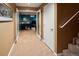 Inviting hallway with a carpeted floor, leading to the recreational room equipped with a foosball table and TV at 250 S Dahlia St, Denver, CO 80246