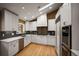 Modern kitchen with stainless steel appliances, white cabinets, and skylight for natural light at 250 S Dahlia St, Denver, CO 80246