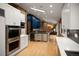 Open concept kitchen with stainless appliances, a wine cooler, and hardwood floors at 250 S Dahlia St, Denver, CO 80246