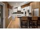 Updated kitchen with white cabinets, stainless appliances, and a center island with bar stools at 250 S Dahlia St, Denver, CO 80246