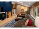 Spacious living room featuring a large sectional, custom shelving, and a unique blue wall at 250 S Dahlia St, Denver, CO 80246