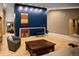 Bright living room features a blue accent wall, wood floors, and a unique fireplace at 250 S Dahlia St, Denver, CO 80246