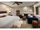 Comfortable bedroom with a bed, blue couch, and a ceiling fan at 250 S Dahlia St, Denver, CO 80246