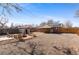 Backyard with a brick patio, fire pit, minimal landscaping, and a storage shed at 2738 Xanadu St, Aurora, CO 80011