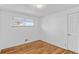 Cozy bedroom featuring hardwood floors, a large window, and neutral walls at 2738 Xanadu St, Aurora, CO 80011