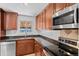 Functional kitchen with stainless steel appliances, dark countertops, and ample cabinet space at 2738 Xanadu St, Aurora, CO 80011