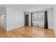 Bright living room featuring hardwood floors, white walls, and neutral window treatments at 2738 Xanadu St, Aurora, CO 80011