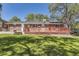 Well manicured backyard with a large deck, yard and bench at 8258 Cherokee St, Denver, CO 80221