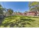 Spacious backyard with lush lawn, privacy fence, and a deck for outdoor living at 8258 Cherokee St, Denver, CO 80221