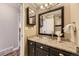 Bathroom featuring vanity, granite counters, glass bowl sink, and framed mirror at 8258 Cherokee St, Denver, CO 80221
