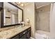 Bathroom with vanity, granite countertop, glass bowl sink, and shower/tub combo at 8258 Cherokee St, Denver, CO 80221