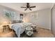 Bright bedroom featuring a ceiling fan, neutral walls, and a large window at 8258 Cherokee St, Denver, CO 80221