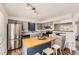 Spacious kitchen featuring a butcher block island with seating, stainless steel appliances, and plenty of counter space at 8258 Cherokee St, Denver, CO 80221