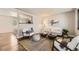 Inviting living room showcasing modern decor, a stylish rug, and an open layout that seamlessly connects to the kitchen at 8258 Cherokee St, Denver, CO 80221