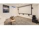 Basement theater with a projector screen, comfortable seating, and entertainment setup at 8258 Cherokee St, Denver, CO 80221
