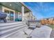 Cozy covered back porch featuring a seating area and a hot tub, ideal for relaxation and entertaining at 1066 S Eaton Park Ct, Aurora, CO 80018