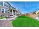 Backyard featuring a seating area with a stone fire pit, grass, and attractive landscaping at 1066 S Eaton Park Ct, Aurora, CO 80018