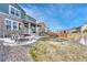 The backyard features a patio with a fire pit and seating, complemented by a gravel area and fenced yard at 1066 S Eaton Park Ct, Aurora, CO 80018