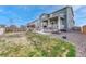 A backyard features a wooden fence, grassy area, patio, and hot tub for outdoor relaxation and entertainment at 1066 S Eaton Park Ct, Aurora, CO 80018