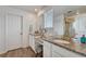 Elegant bathroom featuring double sinks, granite countertops, and ample counter space at 1066 S Eaton Park Ct, Aurora, CO 80018