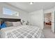 Bright bedroom featuring a comfortable bed, a window with blinds, closet, and a minimalist desk at 1066 S Eaton Park Ct, Aurora, CO 80018