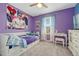 Vibrant purple bedroom featuring a twin bed, desk area, and playful decorative wall art at 1066 S Eaton Park Ct, Aurora, CO 80018