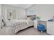 Bright bedroom features a comfortable bed, a window with blinds, and a minimalist desk area at 1066 S Eaton Park Ct, Aurora, CO 80018