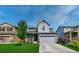 Charming two-story home with a well-manicured lawn, a two-car garage, and a welcoming front porch at 1066 S Eaton Park Ct, Aurora, CO 80018