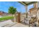 Cozy front porch featuring comfortable seating, stone accents, and a view of the neighborhood at 1066 S Eaton Park Ct, Aurora, CO 80018