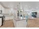 Open-concept kitchen with granite counters, stainless appliances, and an adjacent living space at 1066 S Eaton Park Ct, Aurora, CO 80018