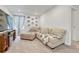 Cozy living room featuring plush seating, soft carpet, and charming decorative touches throughout the room at 1066 S Eaton Park Ct, Aurora, CO 80018