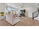 Comfortable living room featuring a cozy fireplace, large windows, and contemporary decor at 1066 S Eaton Park Ct, Aurora, CO 80018