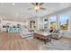 Open-concept living room and kitchen area, perfect for entertaining, with lots of natural light and wood floors at 1066 S Eaton Park Ct, Aurora, CO 80018