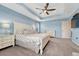 Spacious main bedroom with tray ceiling, ceiling fan, and ample storage provided by matching nightstands at 1066 S Eaton Park Ct, Aurora, CO 80018