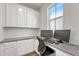 Functional home office with built-in cabinets, granite countertops, and natural light at 1066 S Eaton Park Ct, Aurora, CO 80018