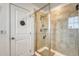 Modern shower featuring glass enclosure and updated tile throughout the shower at 1066 S Eaton Park Ct, Aurora, CO 80018