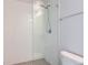 Modern walk-in shower features glass enclosure, sleek fixtures, and tiled walls at 5530 W 11Th Pl, Lakewood, CO 80214