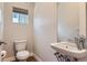 Modern powder room featuring stylish fixtures, vanity mirror, and window at 5530 W 11Th Pl, Lakewood, CO 80214