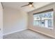 Bright bedroom with neutral carpeting, a ceiling fan, and a window overlooking the neighborhood at 5530 W 11Th Pl, Lakewood, CO 80214