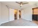 Well-lit bedroom featuring a ceiling fan, closet with sliding doors, and access to the bathroom at 5530 W 11Th Pl, Lakewood, CO 80214