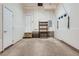 Open garage with storage shelving and a white door leading to the inside of the home at 5530 W 11Th Pl, Lakewood, CO 80214
