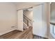 Bright hallway with barn doors, sleek flooring, and access to staircase at 5530 W 11Th Pl, Lakewood, CO 80214