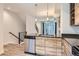 Modern kitchen with island, stainless steel appliances, and wood-look cabinets at 5530 W 11Th Pl, Lakewood, CO 80214