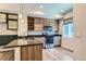 Kitchen features sleek appliances, ample counter space, and stylish wooden cabinetry at 5530 W 11Th Pl, Lakewood, CO 80214