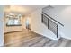 Bright living room boasts modern staircase, hardwood floors, and seamless access to the kitchen at 5530 W 11Th Pl, Lakewood, CO 80214