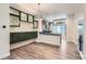 Open-concept living room with modern light fixtures and luxury vinyl plank flooring at 5530 W 11Th Pl, Lakewood, CO 80214