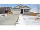 Charming home featuring a two-car garage, covered porch, and partial stone accents at 6501 14Th St, Frederick, CO 80530