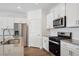 Modern kitchen featuring stainless steel appliances, white cabinetry, and a functional layout at 6501 14Th St, Frederick, CO 80530