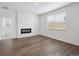 Bright living room featuring an electric fireplace and large window at 6501 14Th St, Frederick, CO 80530