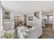 Spacious living room with hardwood floors, white couch, and a view to kitchen at 3274 Belleville Ridge Rd, Elizabeth, CO 80107